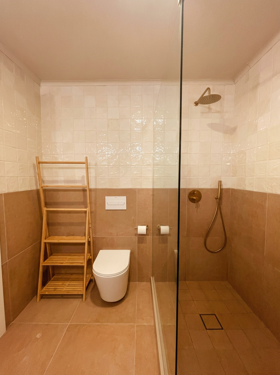 Walk-in rain shower with warm terracotta tiles